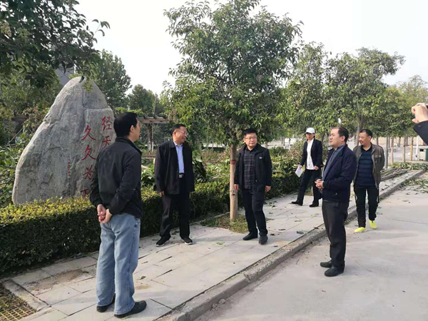 校长丁庭选(左二)亲临“校友林”栽种现场